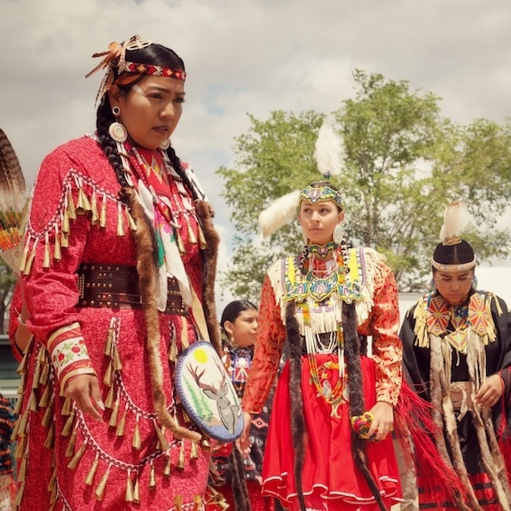 Women in regalia at annual powwow